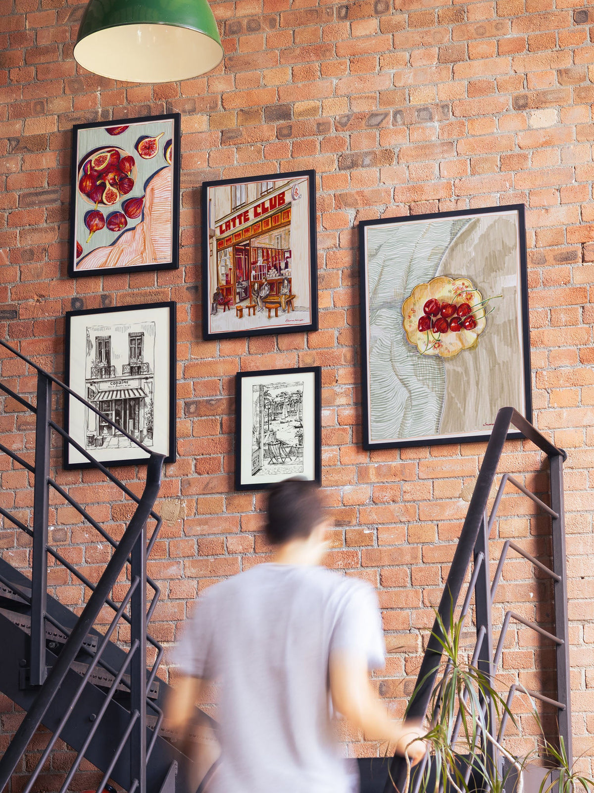 A gallery wall of framed art prints hung above furniture