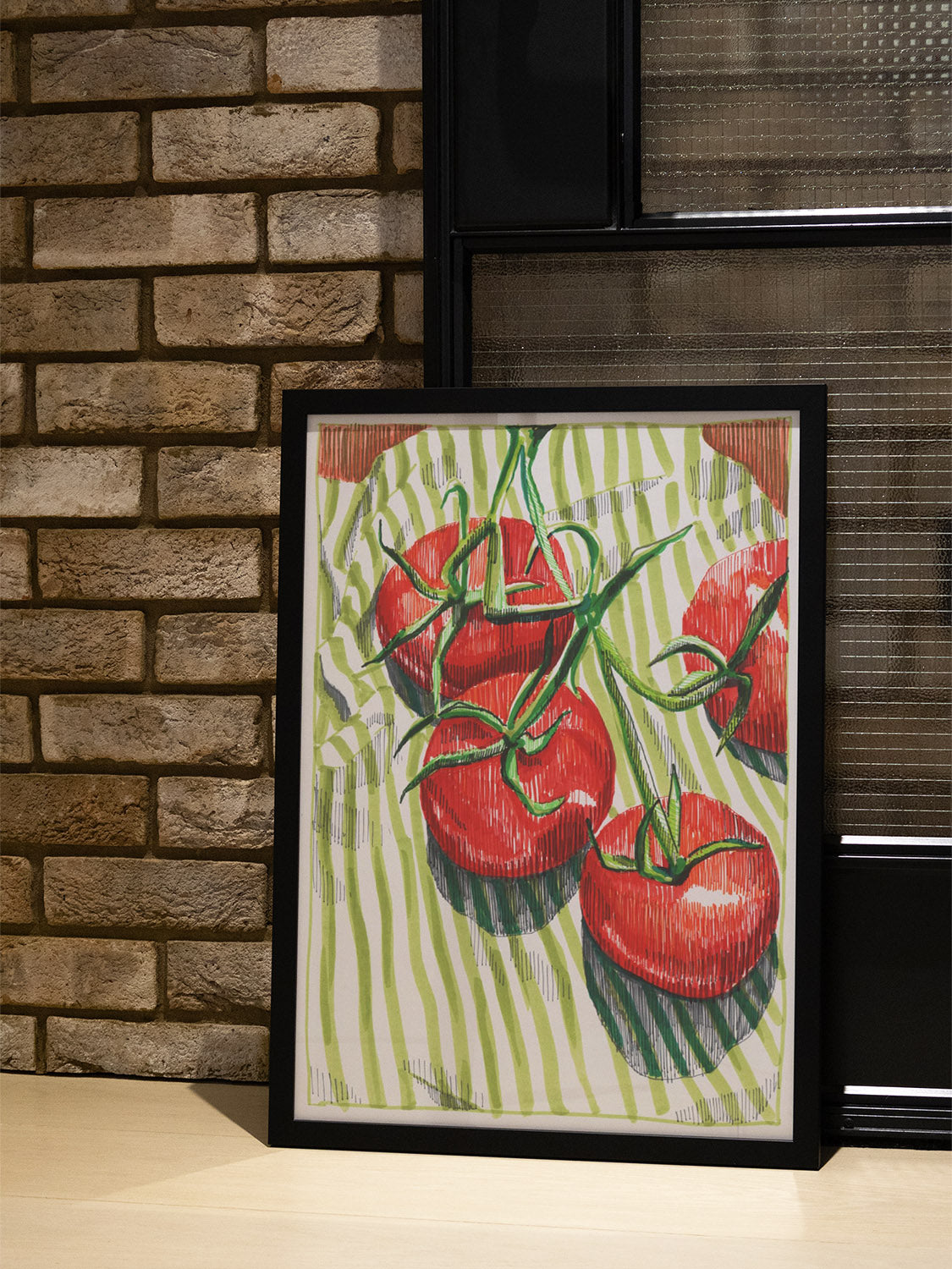 "Vine Tomatoes" by Emma Louise in black frame, lifestyle photo showing artwork in stylish interior setting. |type=lifestyle|