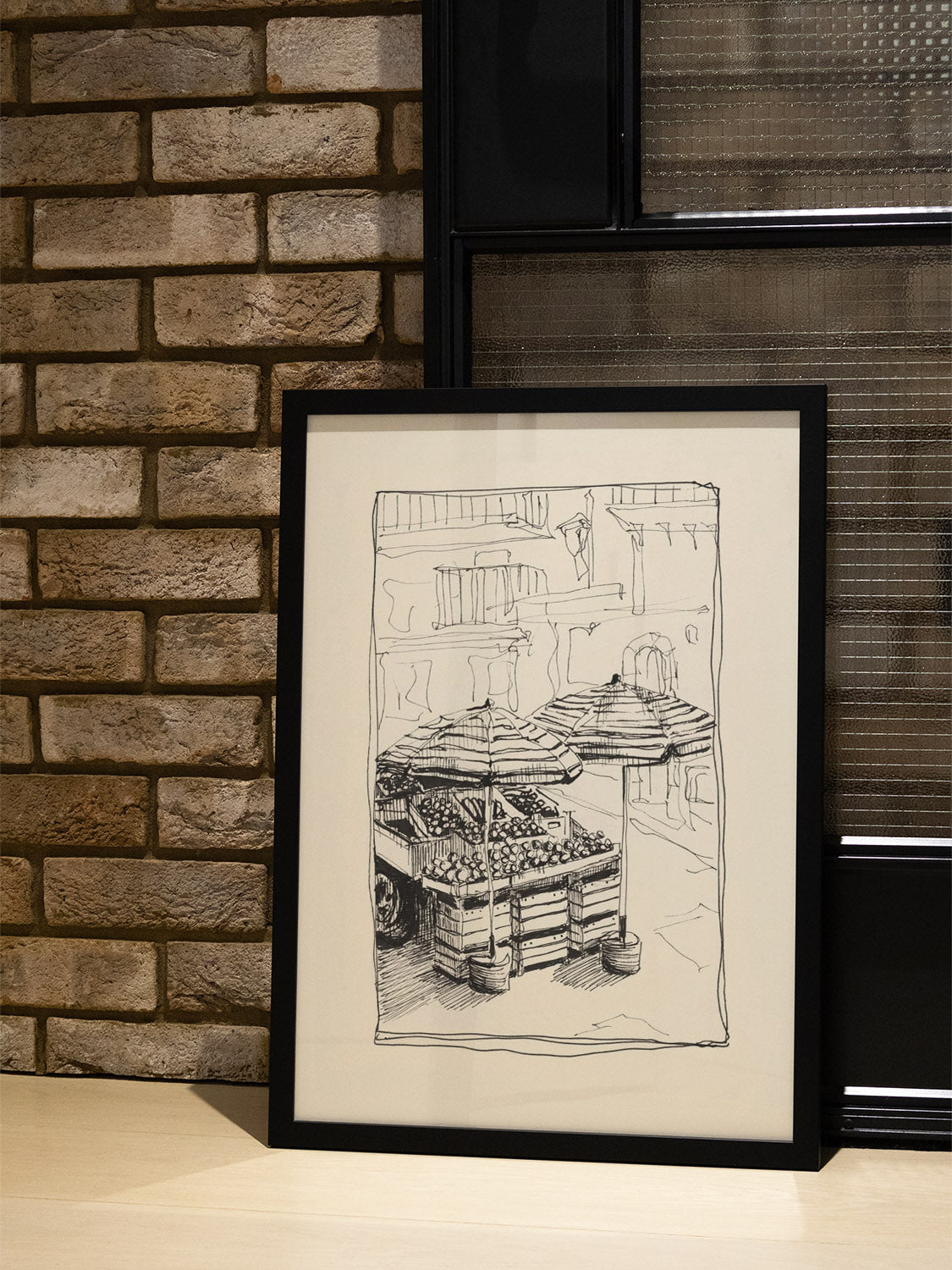 "Fruit Stands" by Emma Louise in black frame displayed in stylish interior setting showing vibrant fruit market scene |type=lifestyle|