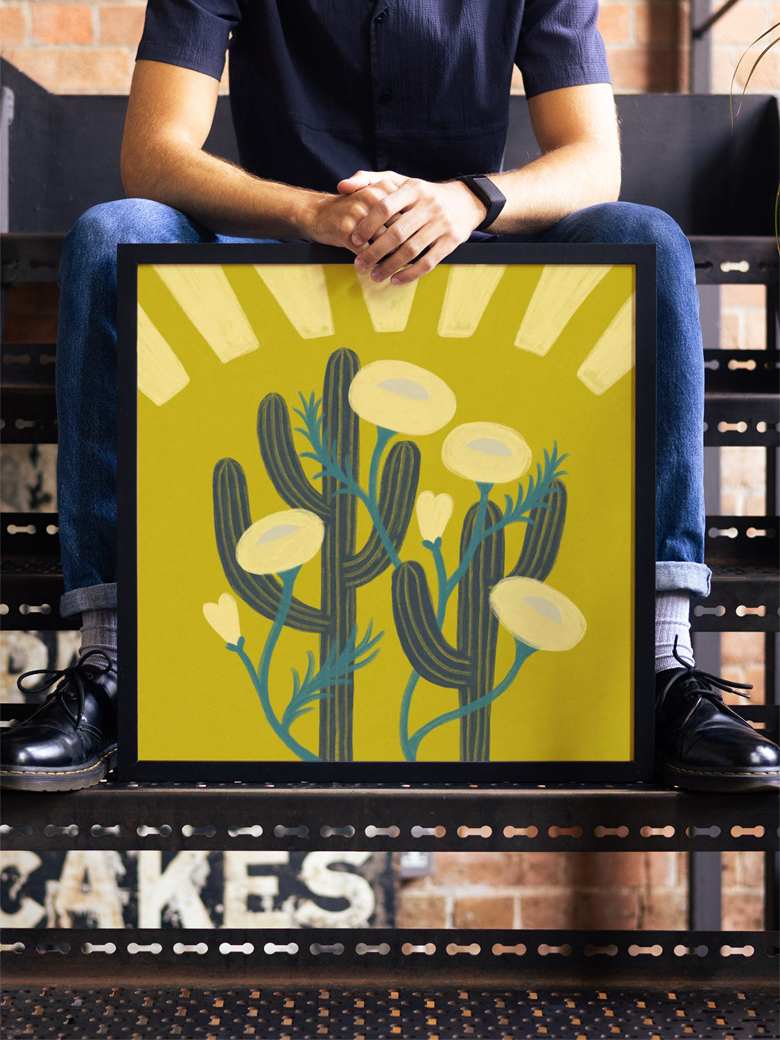 "Sunrise Cacti" by Sophia Sky in black frame displayed in a styled interior setting. |type=lifestyle|