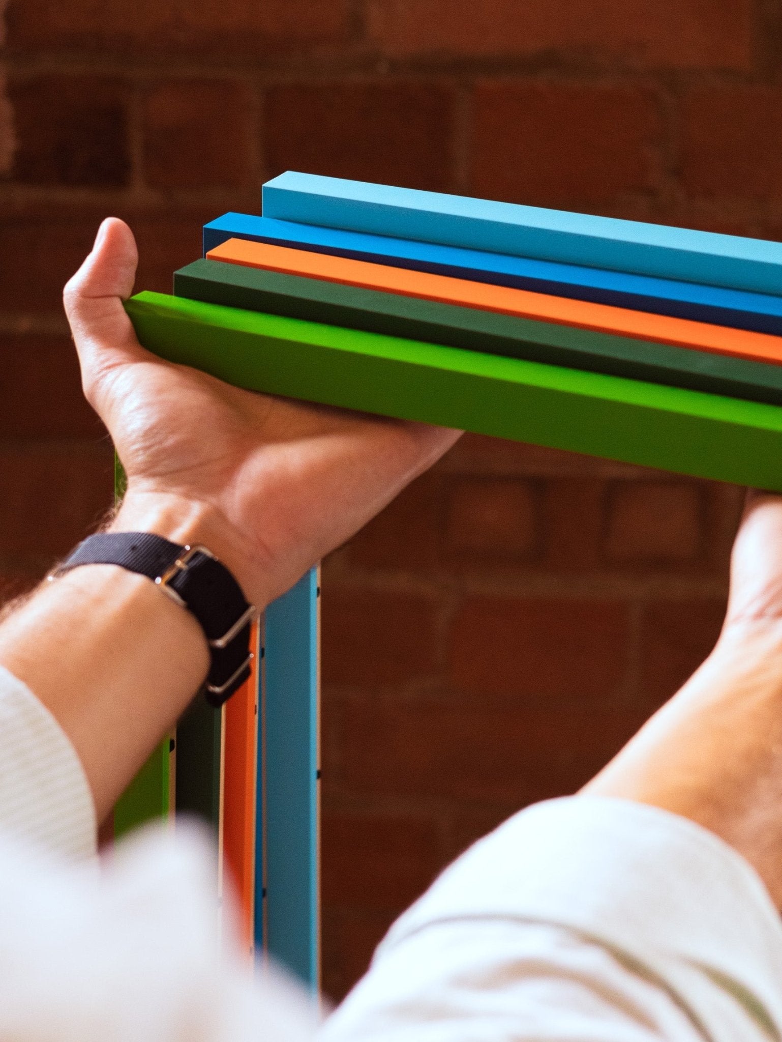 Forest Green - Premium Wooden Picture Frame held showing slim profile and rich dark green Obeche wood craftsmanship.