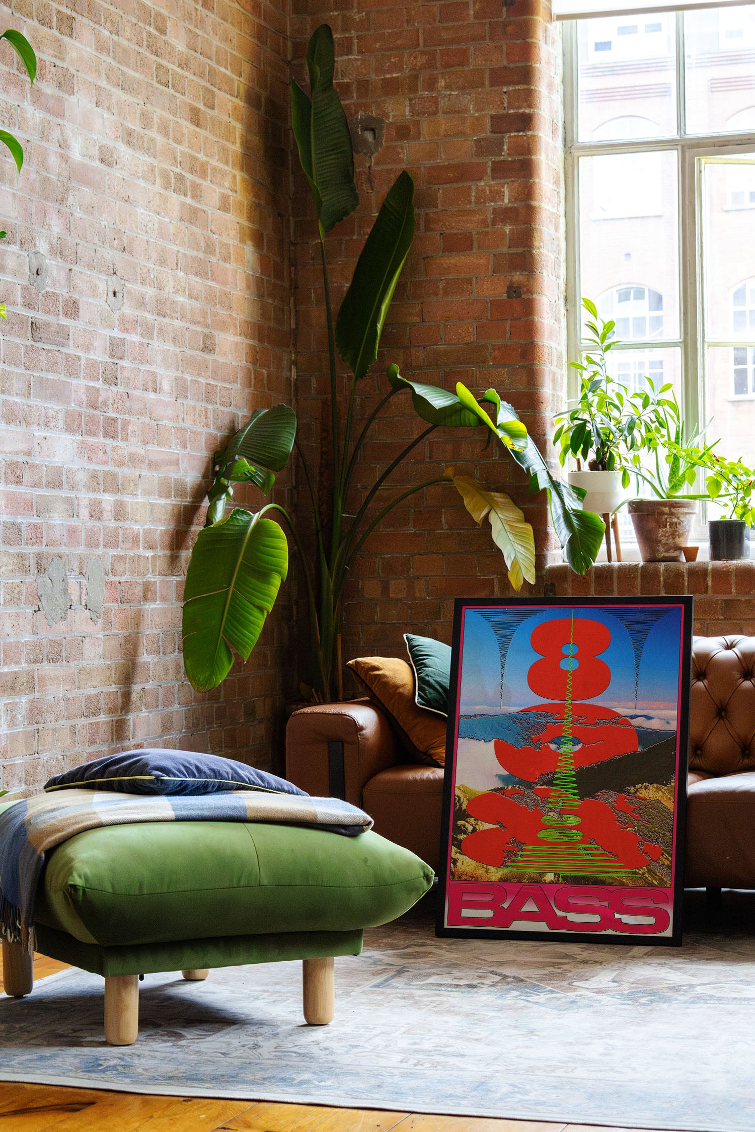 a living room with a couch and a painting on the floor