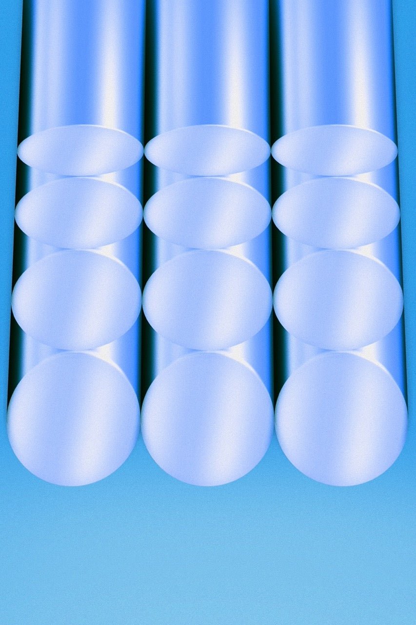 a row of white plastic tubes sitting on top of a blue surface