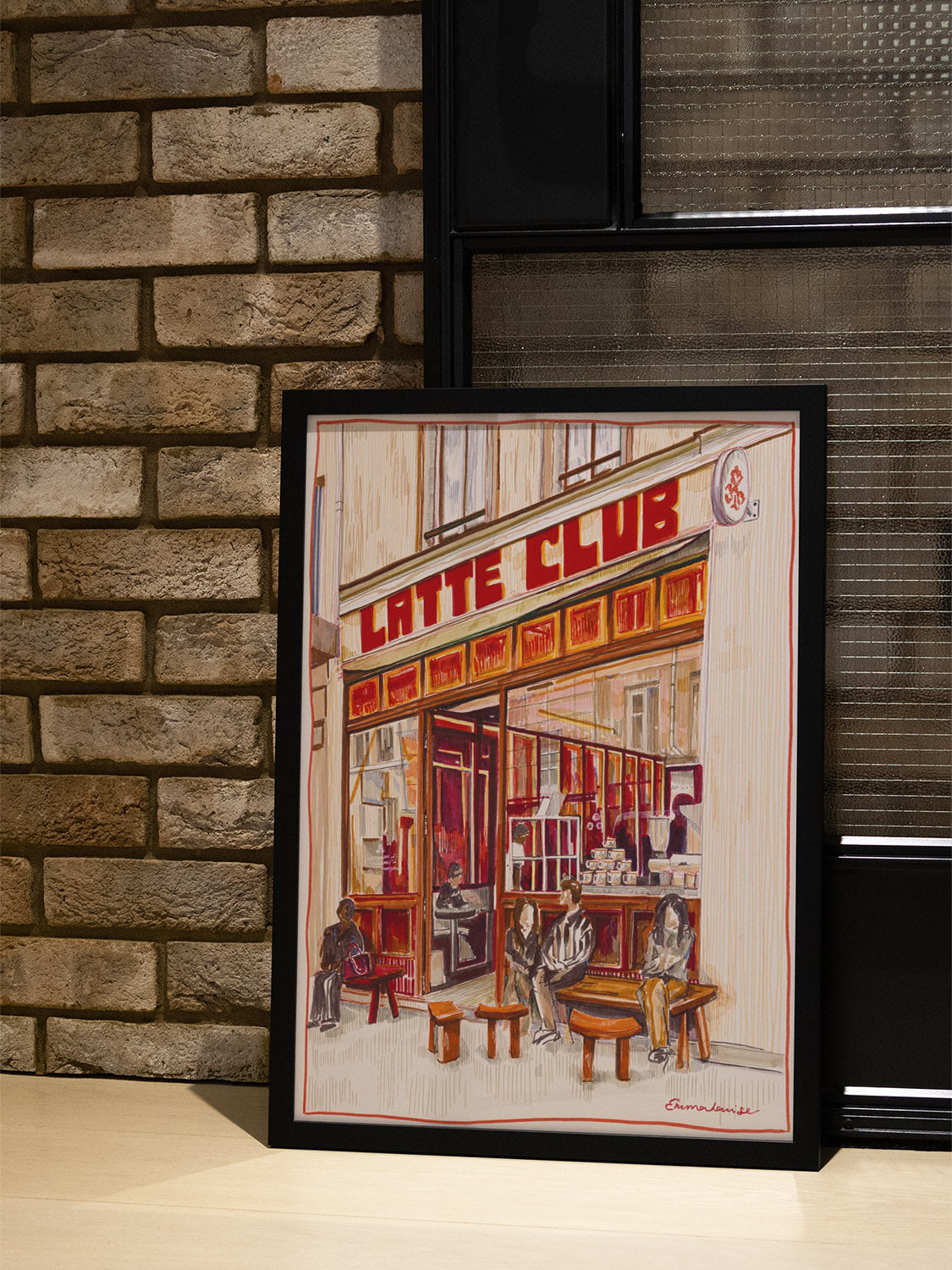 "Latte Club Paris" by Emma Louise in black frame displayed in a styled interior setting. Fine art print. |type=lifestyle|