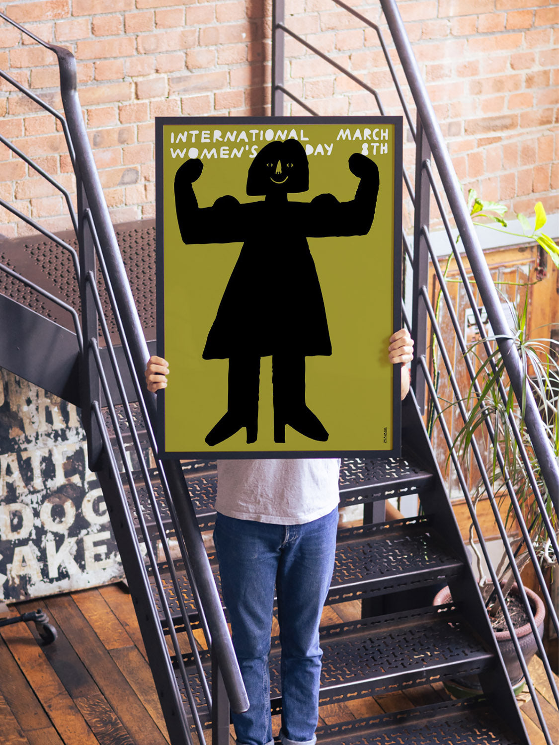 "March 8th | International Women's Day" art by Bartosz Mamak in black frame displayed in styled interior setting. |type=lifestyle|