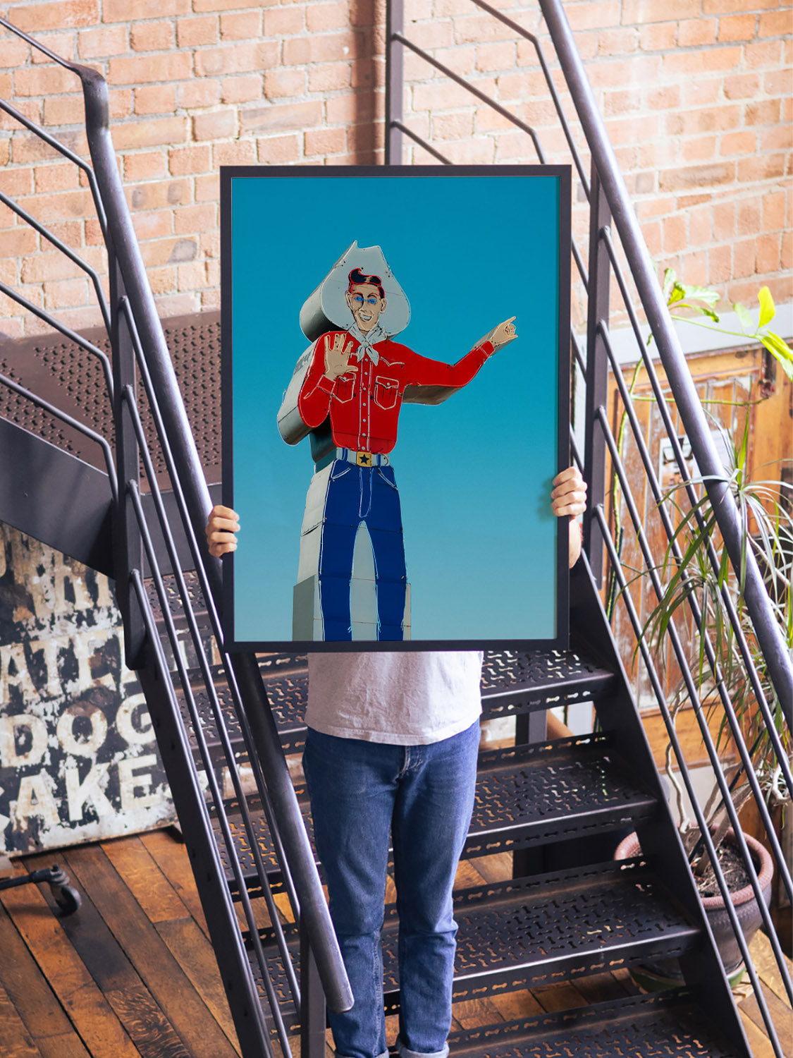 "Head West, Texas" by Philip Jobling, fine art print in black frame displayed in styled interior setting.