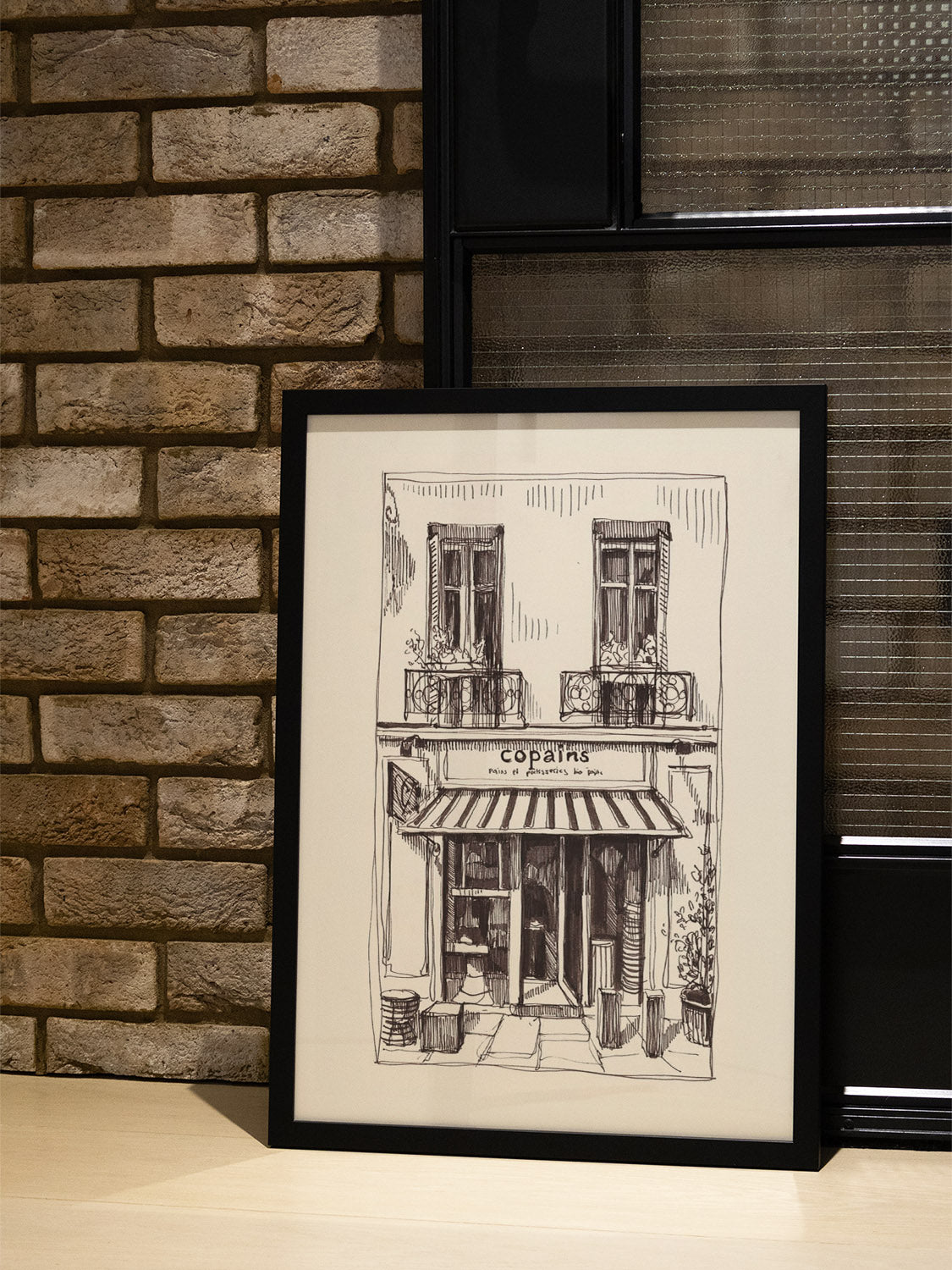 Fine art print "Copains" by Emma Louise in black frame displayed in a styled interior setting. |type=lifestyle|