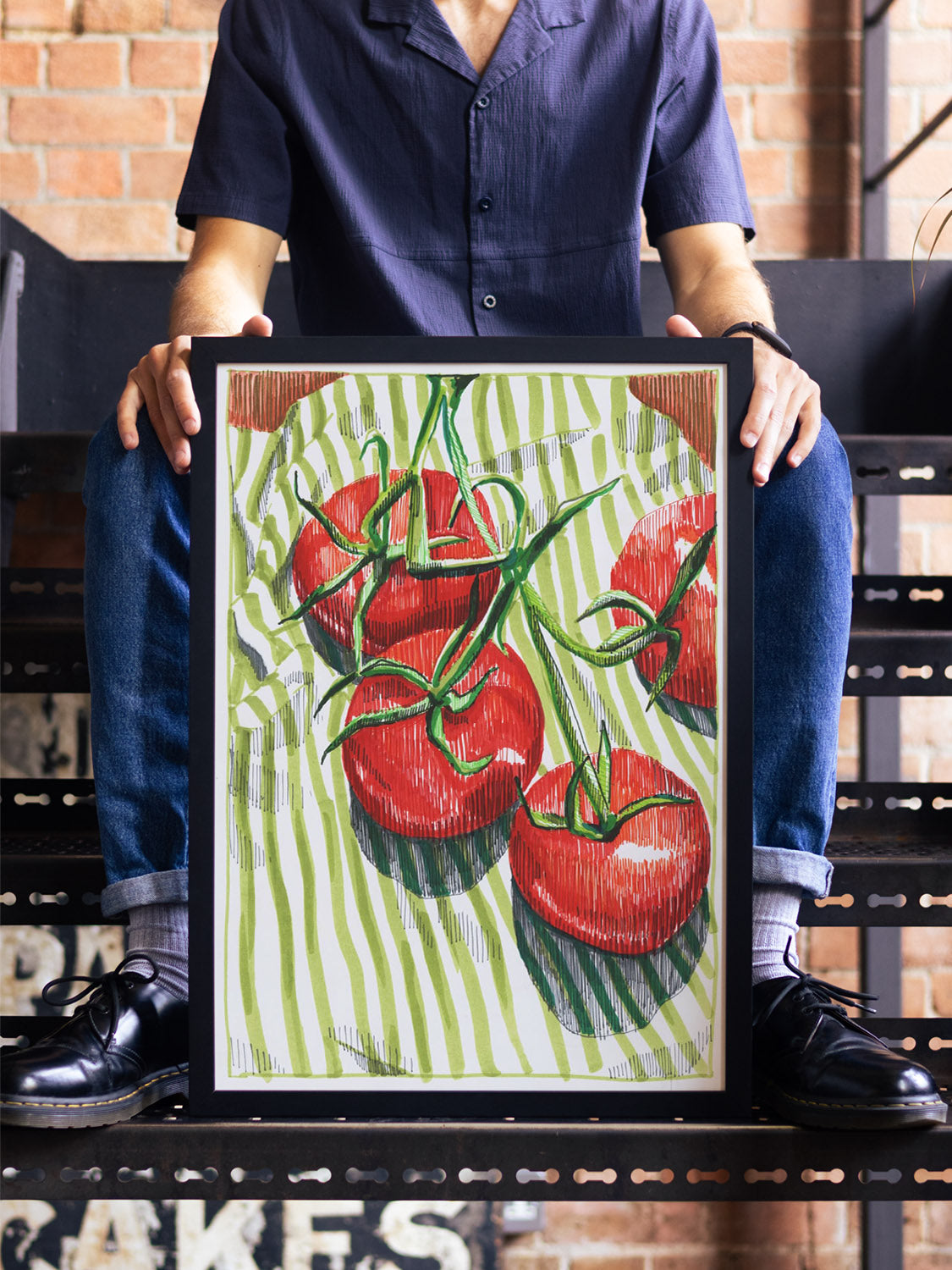 "Vine Tomatoes" artwork by Emma Louise displayed in black frame on styled interior wall. |type=lifestyle|