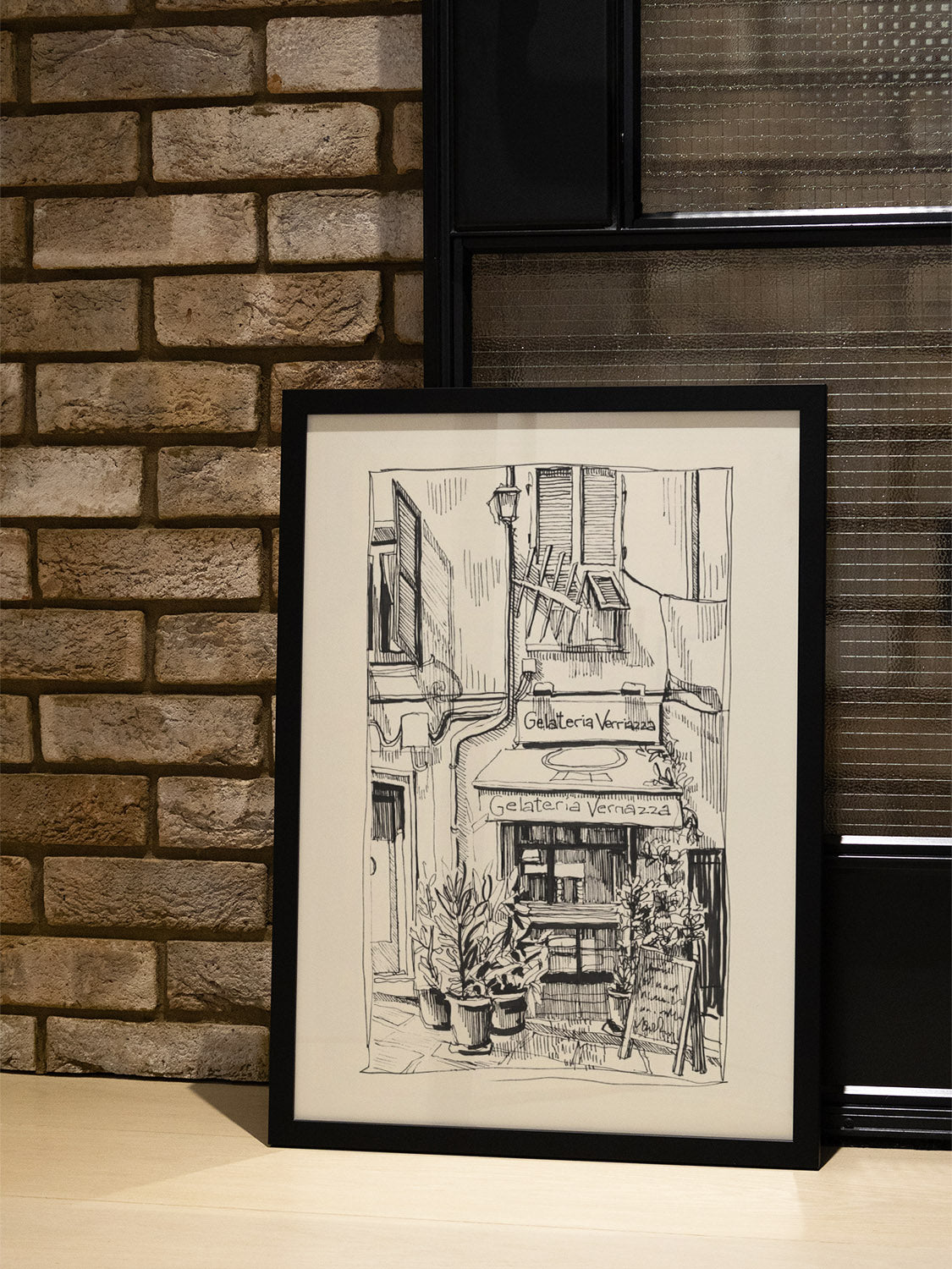 "Sun On Gelateria Verriazza" by Emma Louise, fine art print in black frame displayed in styled interior setting. |type=lifestyle|