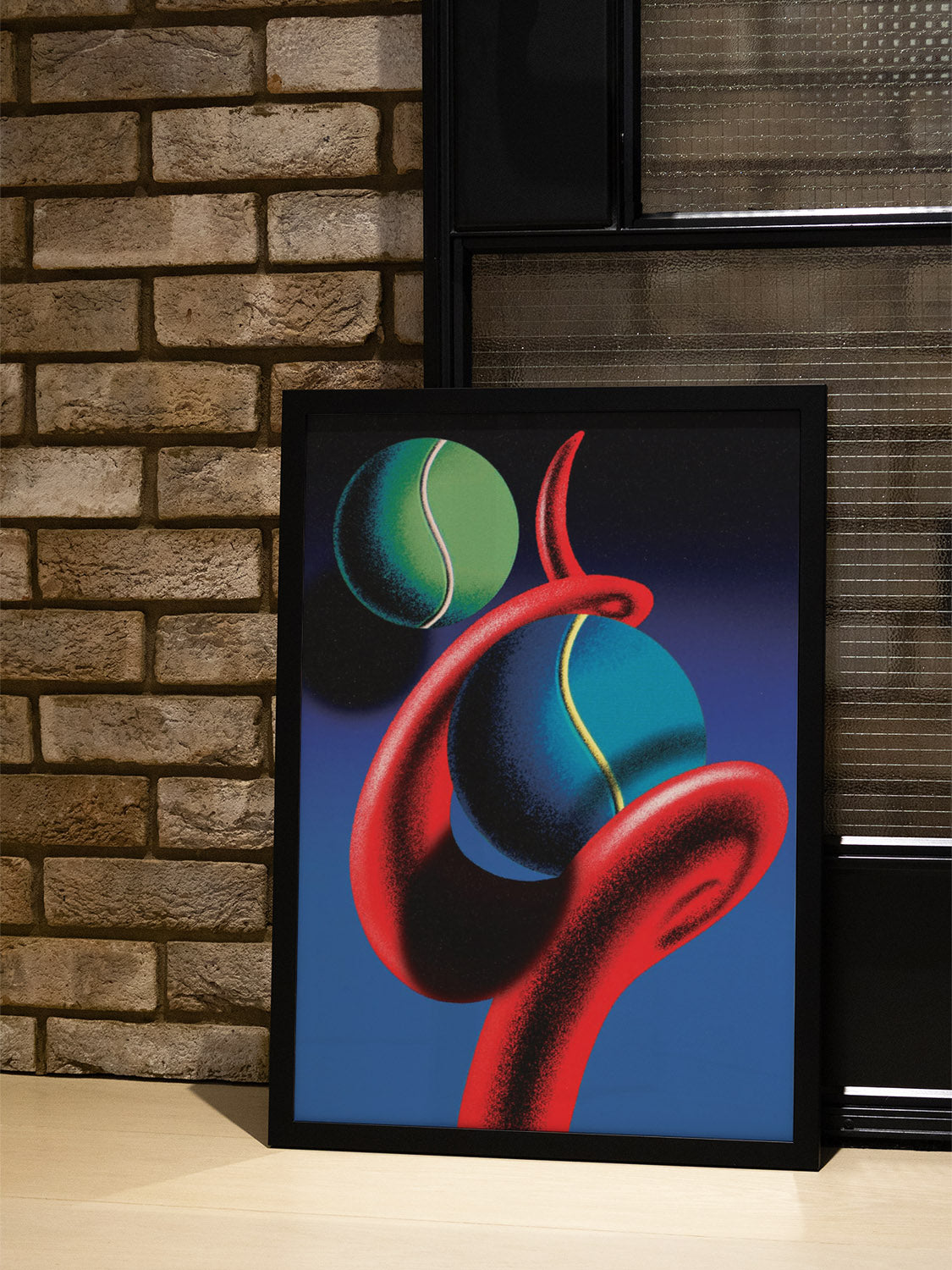 "Spiraling Game" by Sheyi Adebayo in black frame displayed in modern interior setting. |type=lifestyle|